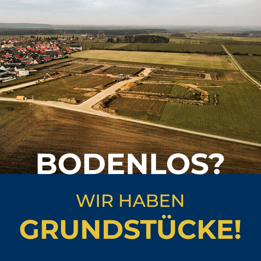 Luftaufnahme eines erschlossenen Baugebiets am Ortsrand mit Straßen und Grundstücksflächen; darunter steht ‚Bodenlos? Wir haben Grundstücke!‘